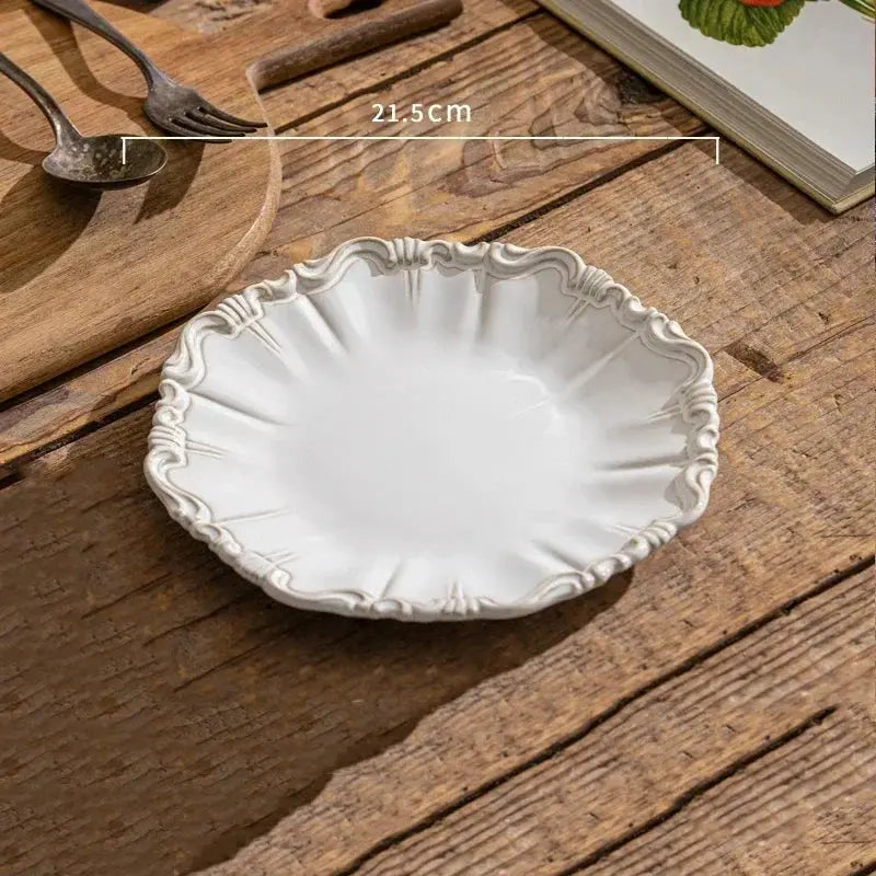 Decorative white ceramic plate on a wooden surface
