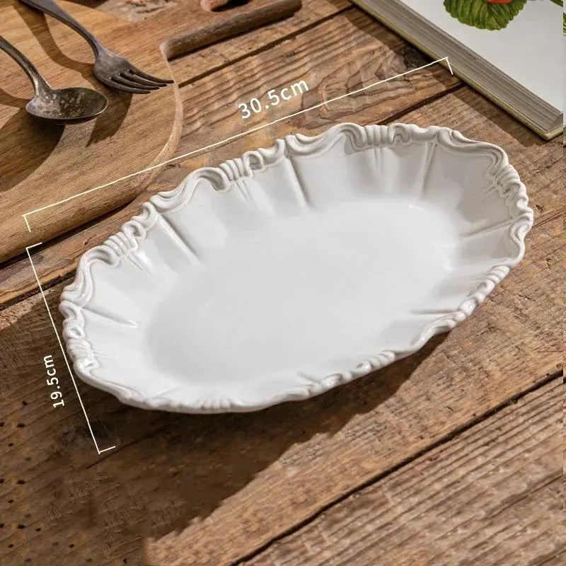White ceramic platter on a wooden surface with measurements