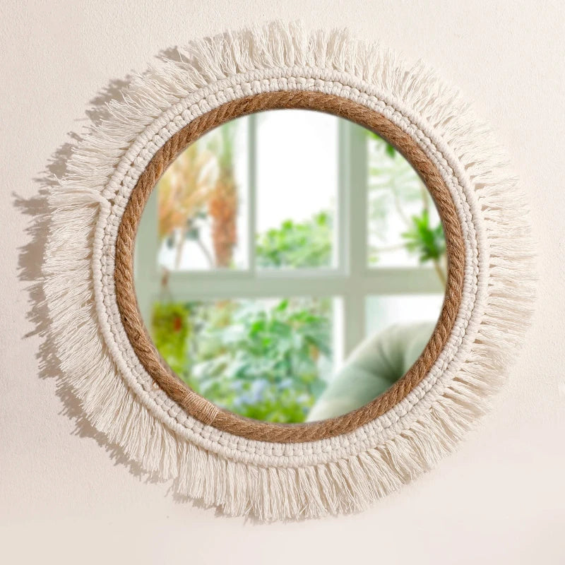 Round mirror with macrame fringe frame on a light background