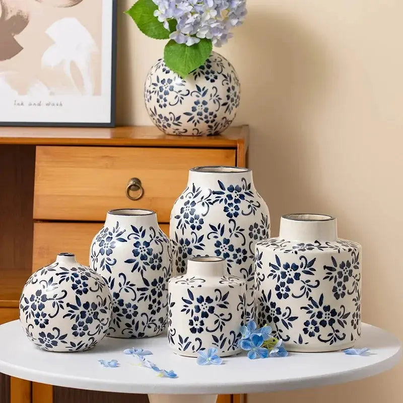 Set of ceramic vases with blue floral patterns on a table