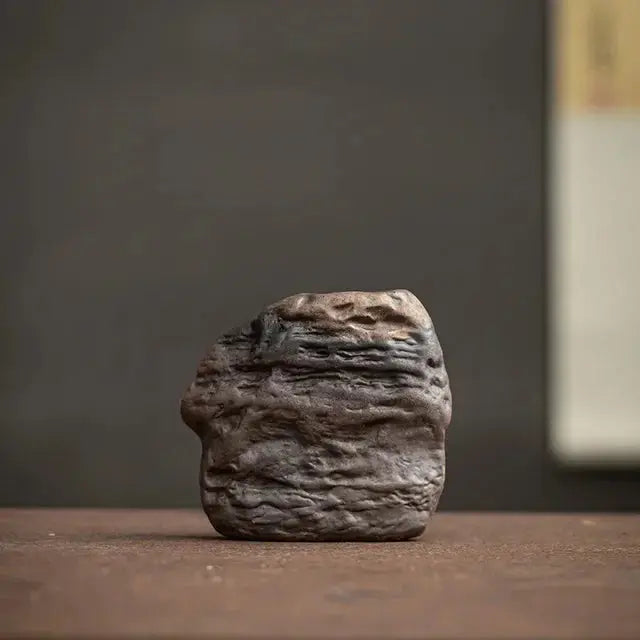 Textured stone object on a wooden surface