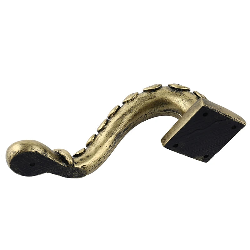 Decorative brass bracket on a white background