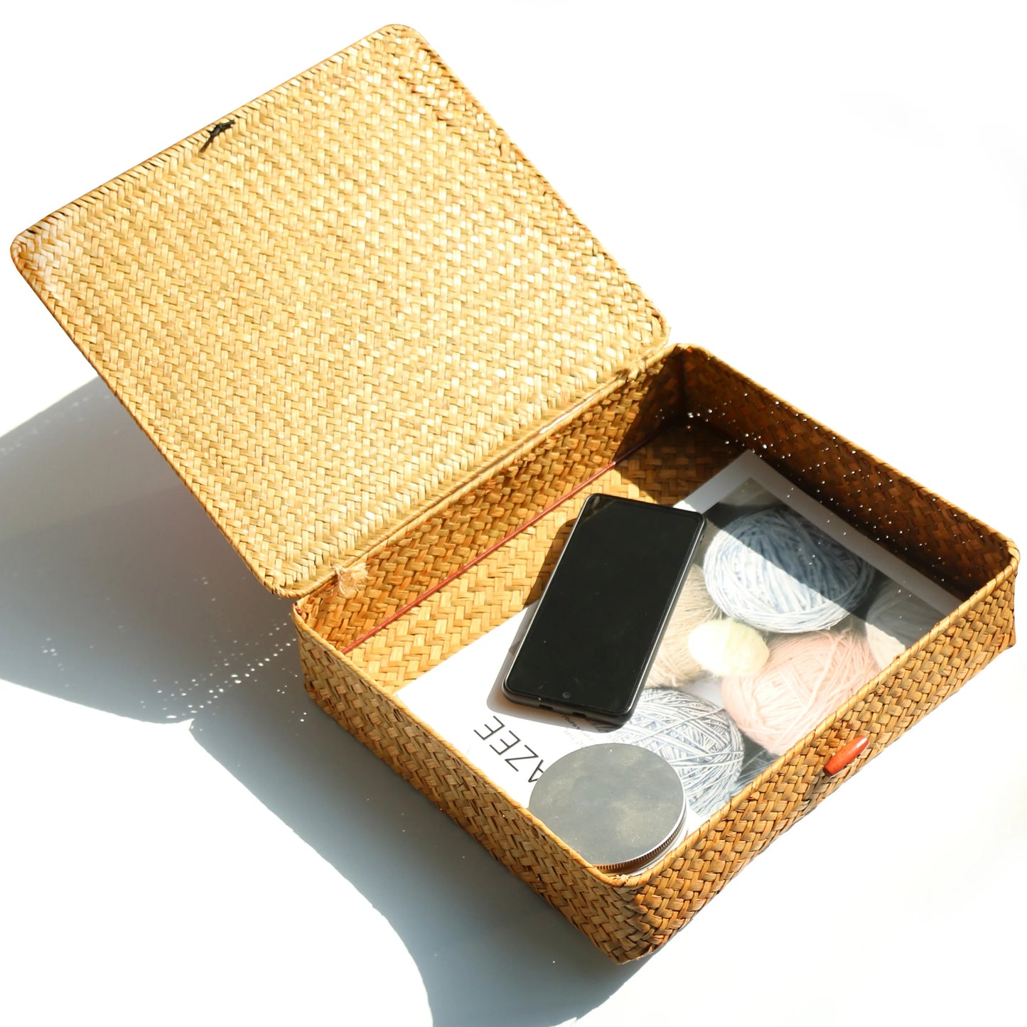 Woven jewelry box with makeup items on a white background