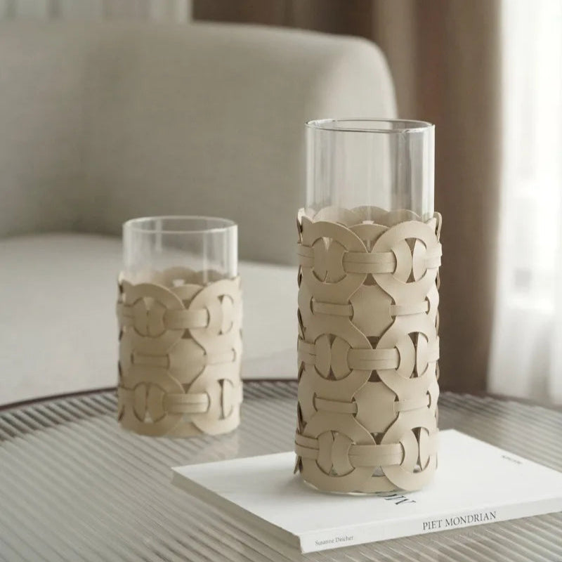 Two decorative vases with intricate patterns on a table.