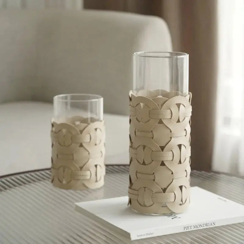 Two decorative vases with intricate patterns on a table.