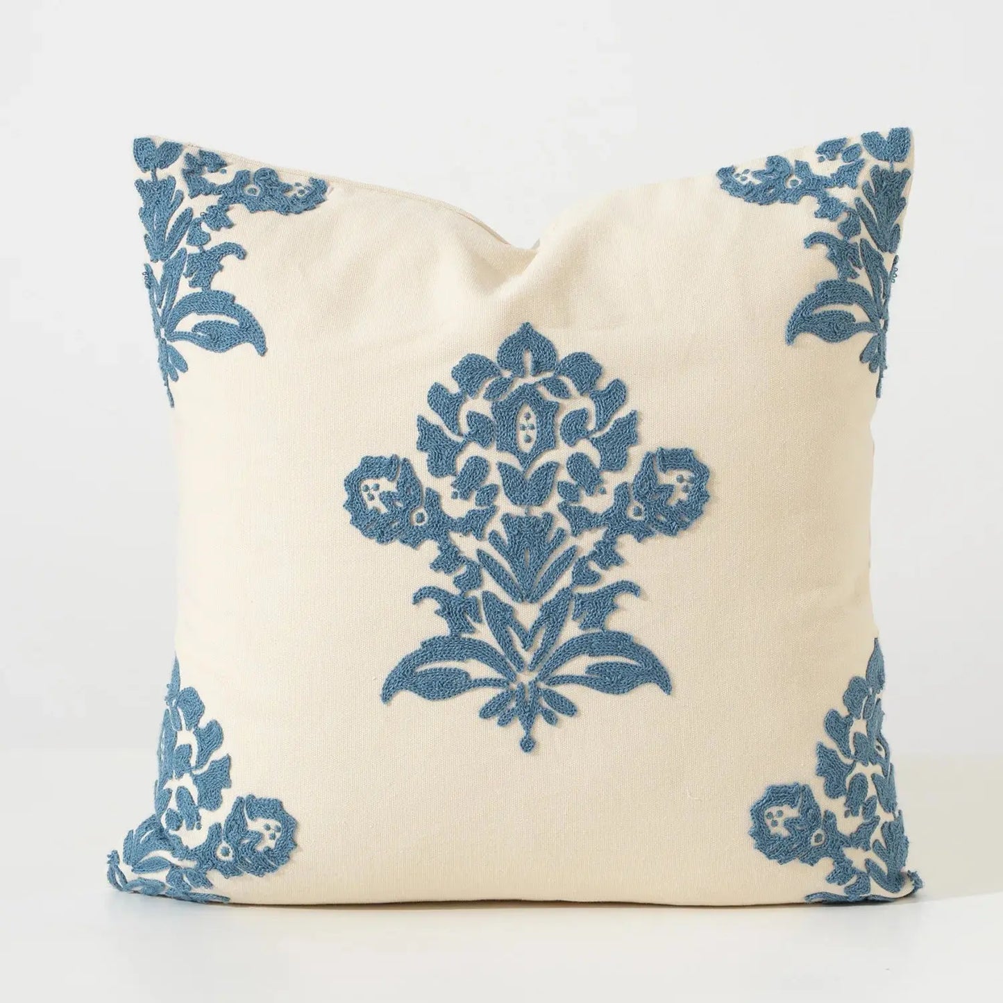 Decorative pillow with blue floral patterns on a white