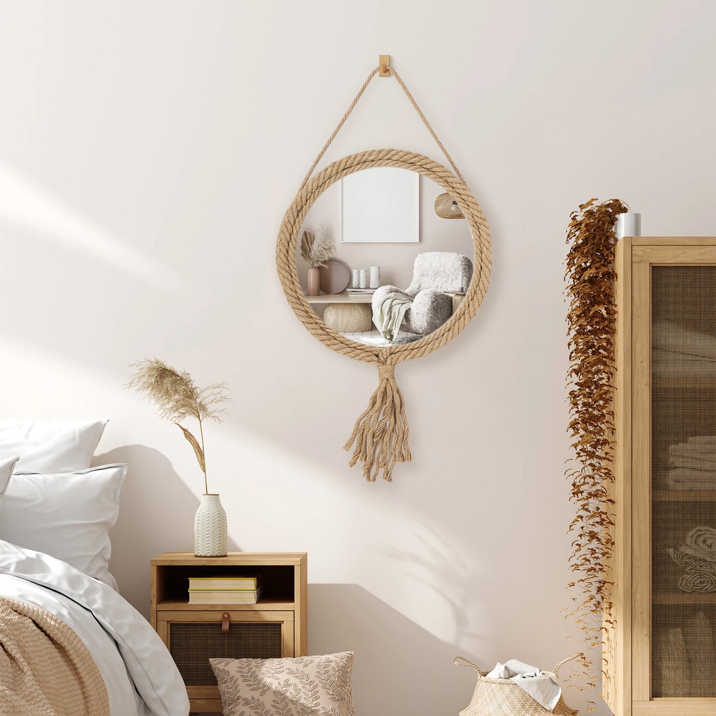 Hanging round mirror with tassels in a bedroom setting