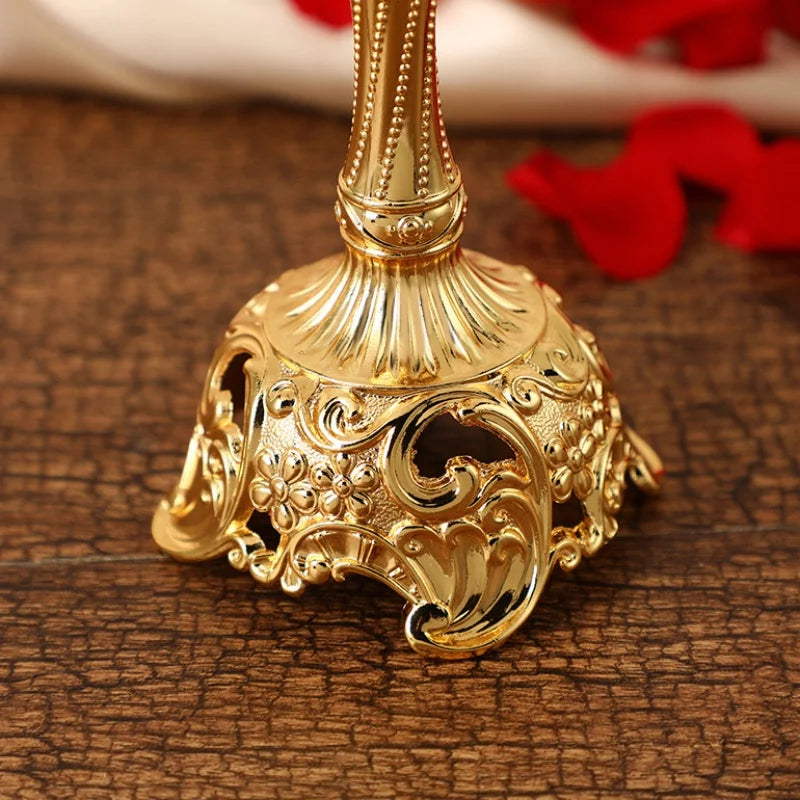 Decorative gold bell with intricate designs on a wooden surface