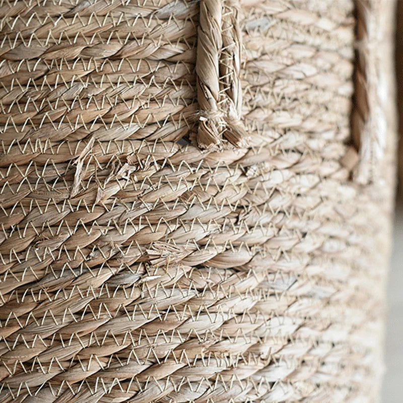 Close-up of a woven straw bag with a geometric pattern.