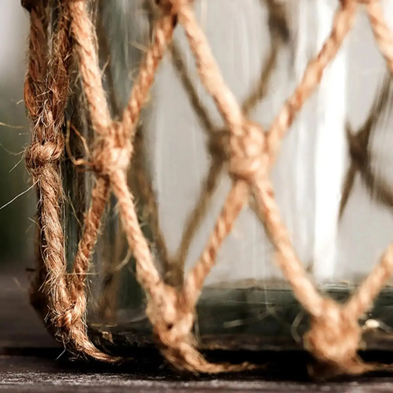Glass jar with rope lid on a wooden surface