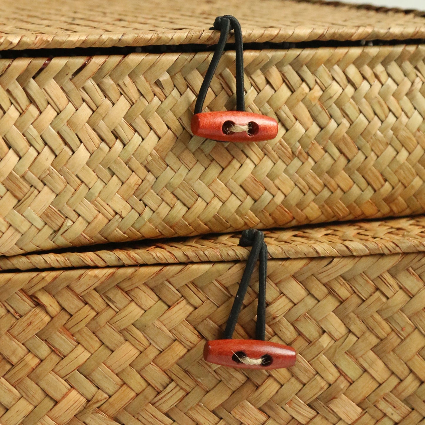 Close-up of a woven basket with wooden handles