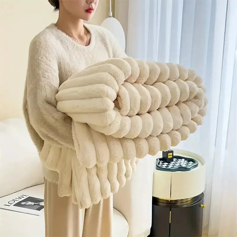 Person holding a large beige blanket in a living room
