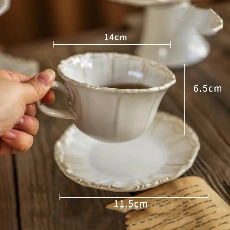 Ceramic teacup and saucer with dimensions on a wood