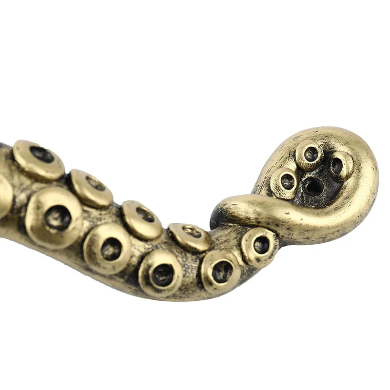 Bronze-colored octopus tentacle on a white background