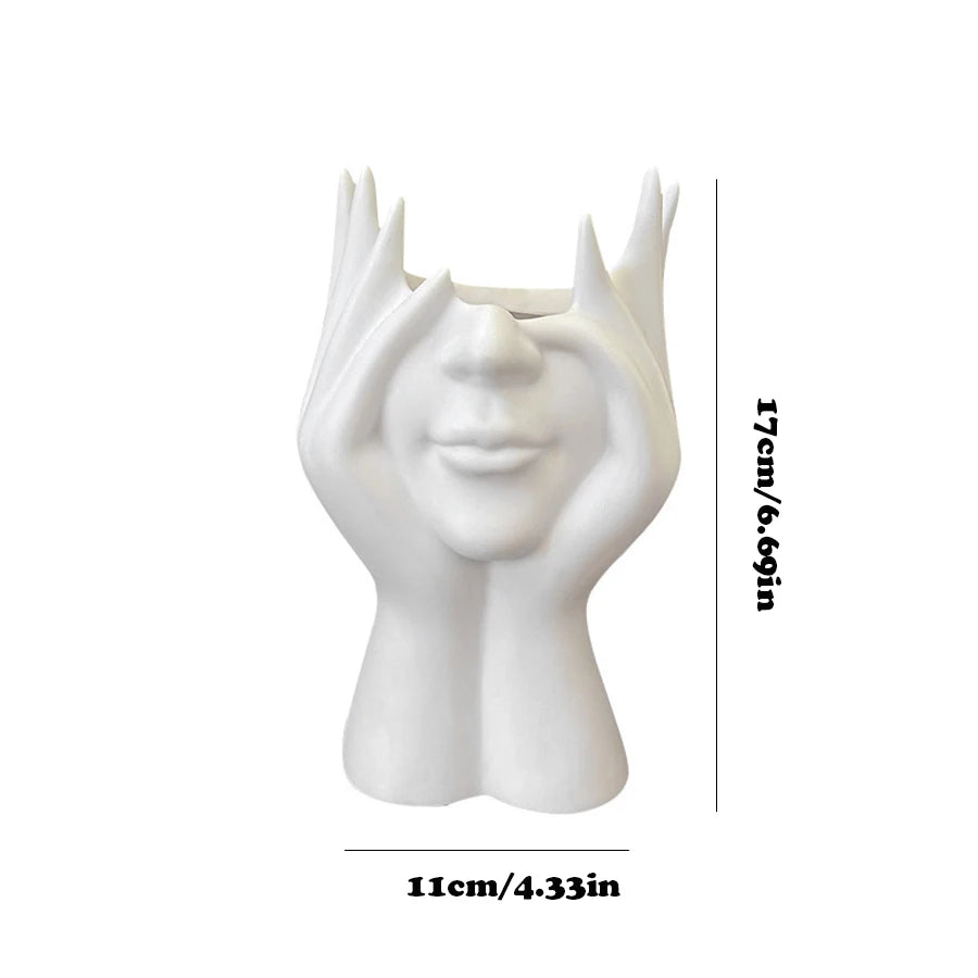 White vase shaped like a face with measurements on a white background