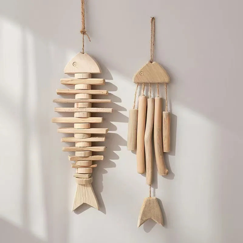 Two wooden fish-shaped decorations hanging against a light background