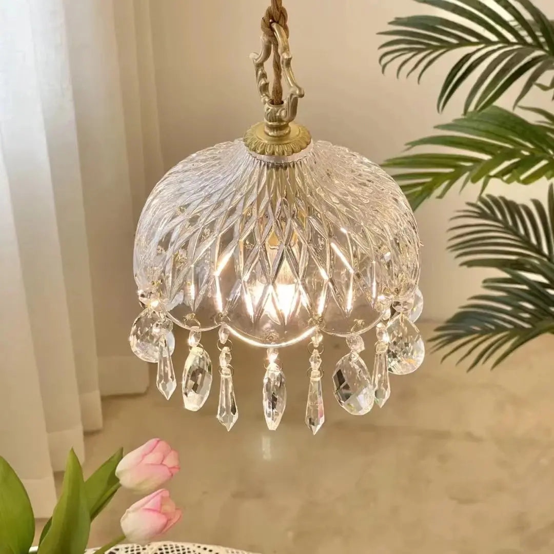Crystal chandelier hanging against a neutral wall