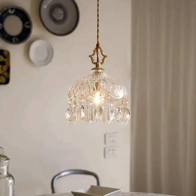 Crystal chandelier hanging against a neutral wall