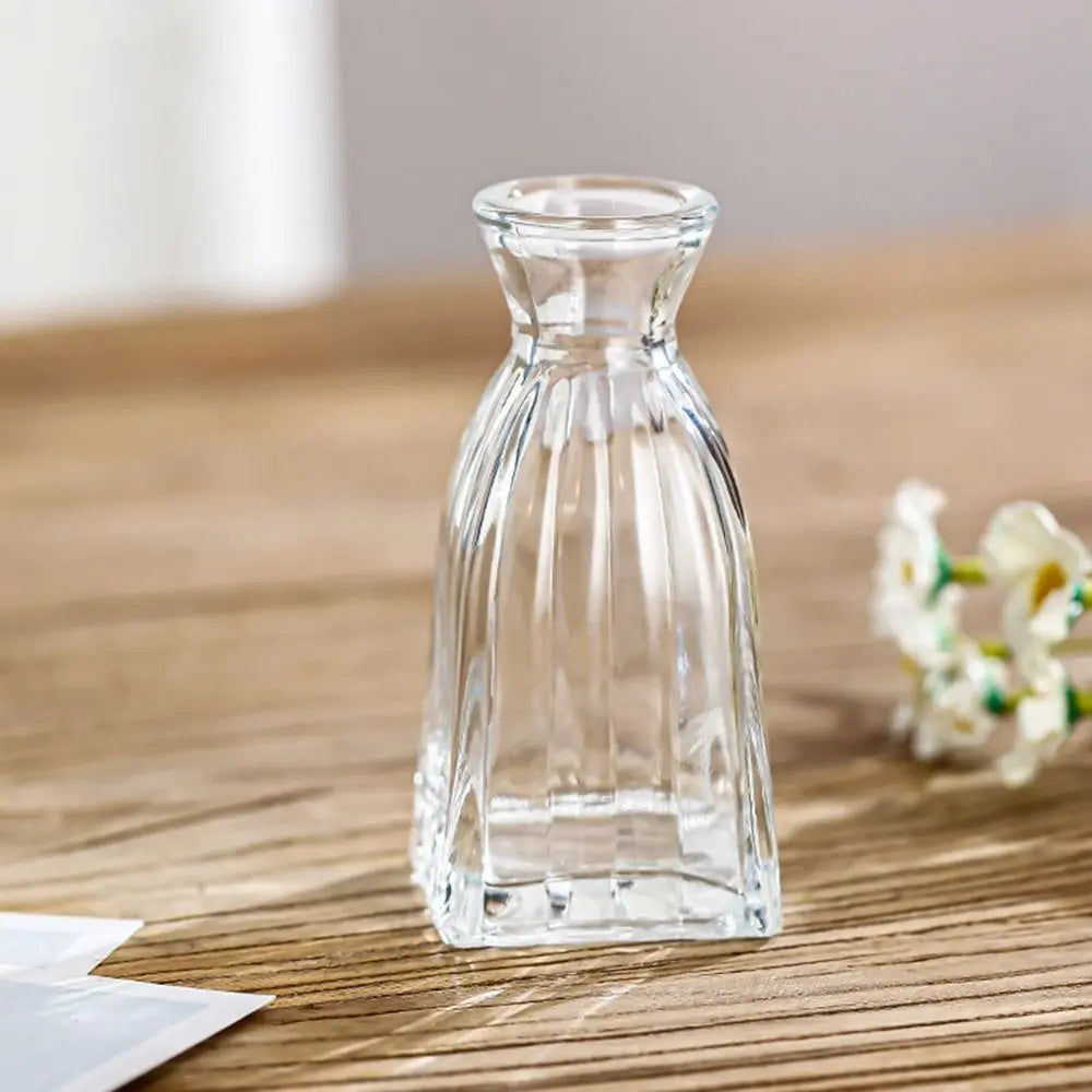 Clear glass carafe on a wooden surface with a blurred background