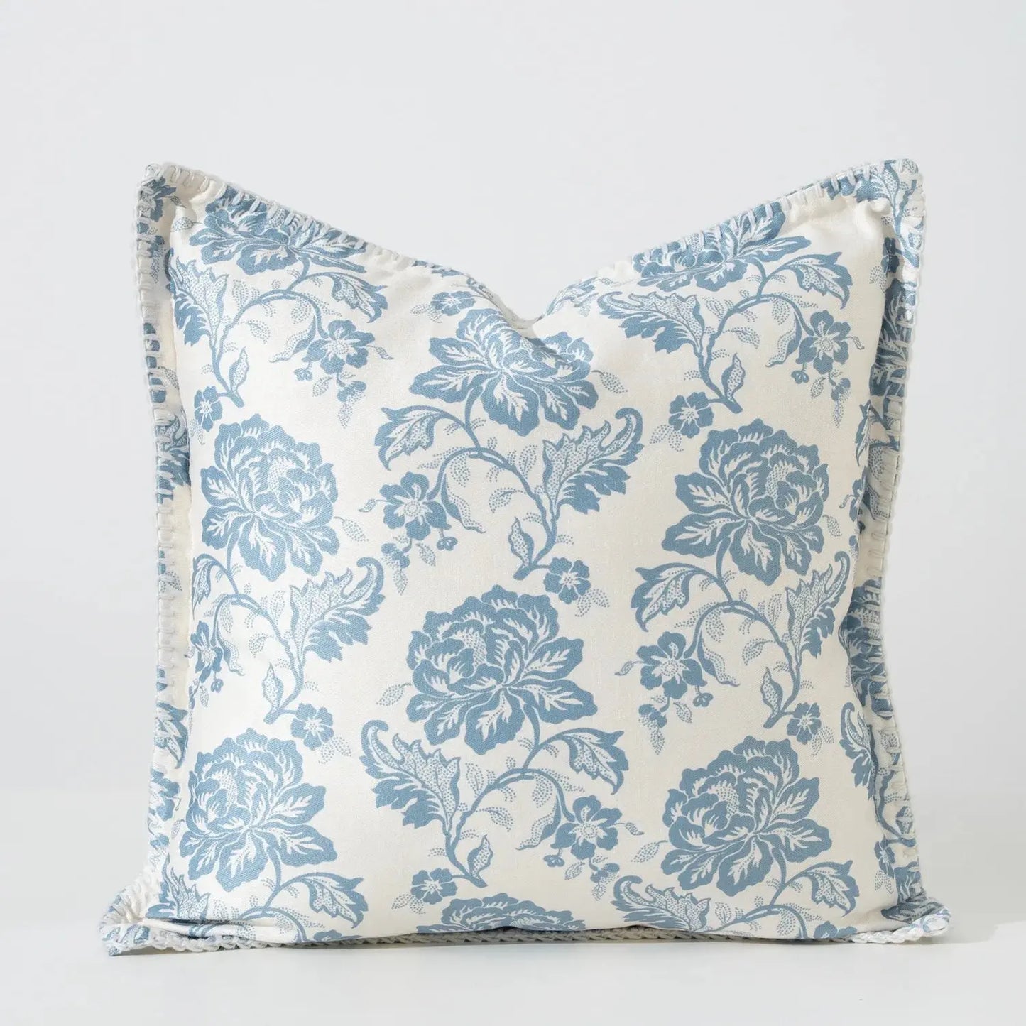 Floral patterned pillow with blue flowers