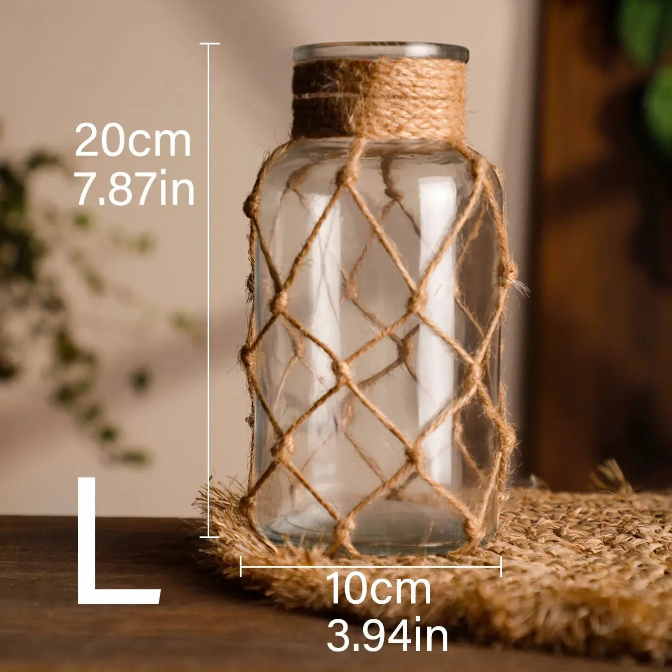 Glass lantern with jute rope netting, placed on a surface