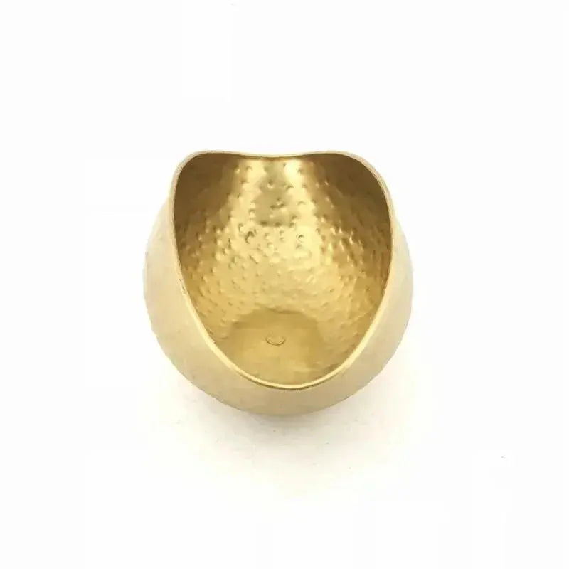 Gold bowl with a textured surface on a white background