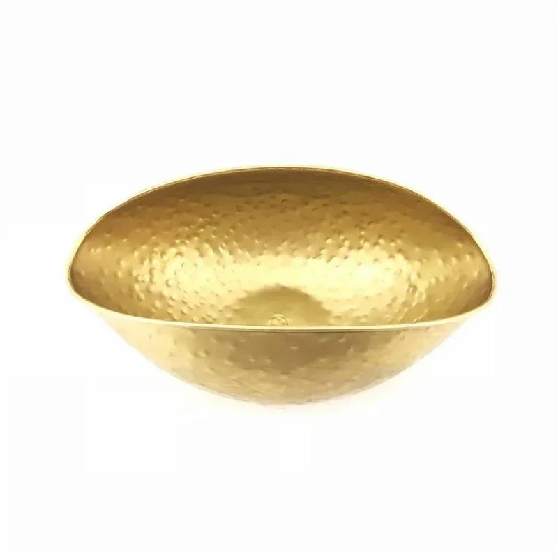 Gold bowl with a textured surface on a white background