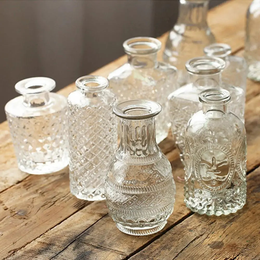 Set of clear glass vases on a wooden surface