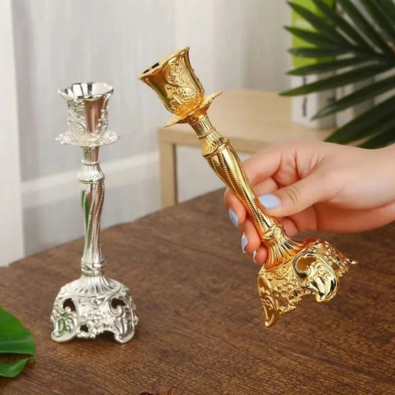 Gold and silver candlestick holders on a wooden surface with a blurred background