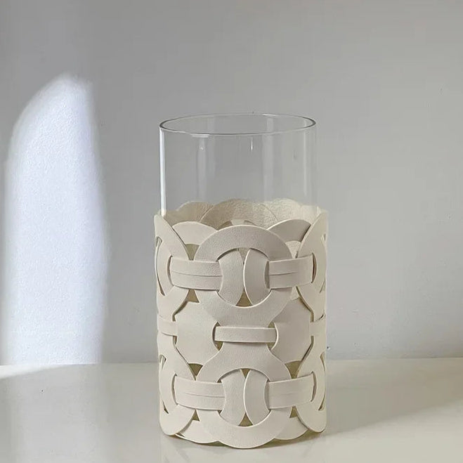 Decorative white vase with intricate patterns on a light gray background