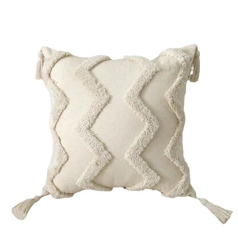 Decorative pillow with zigzag pattern and tassels