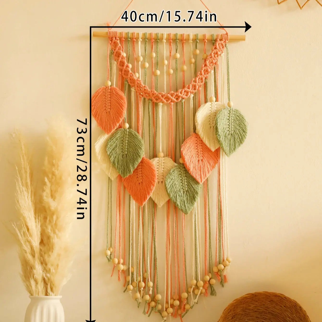 Decorative wall hanging with knitted leaves and string