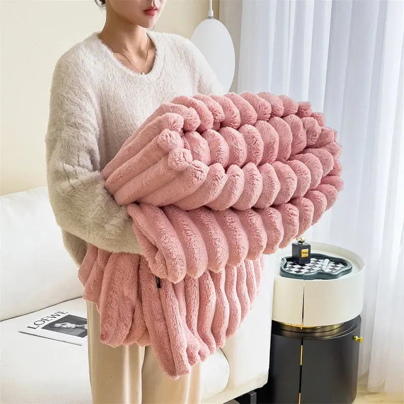 Person holding a large pink textured blanket
