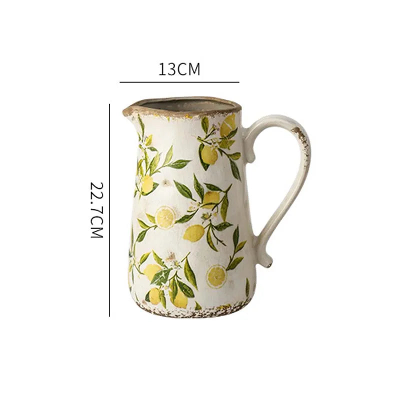 Ceramic pitcher with lemon pattern and measurements on a white background