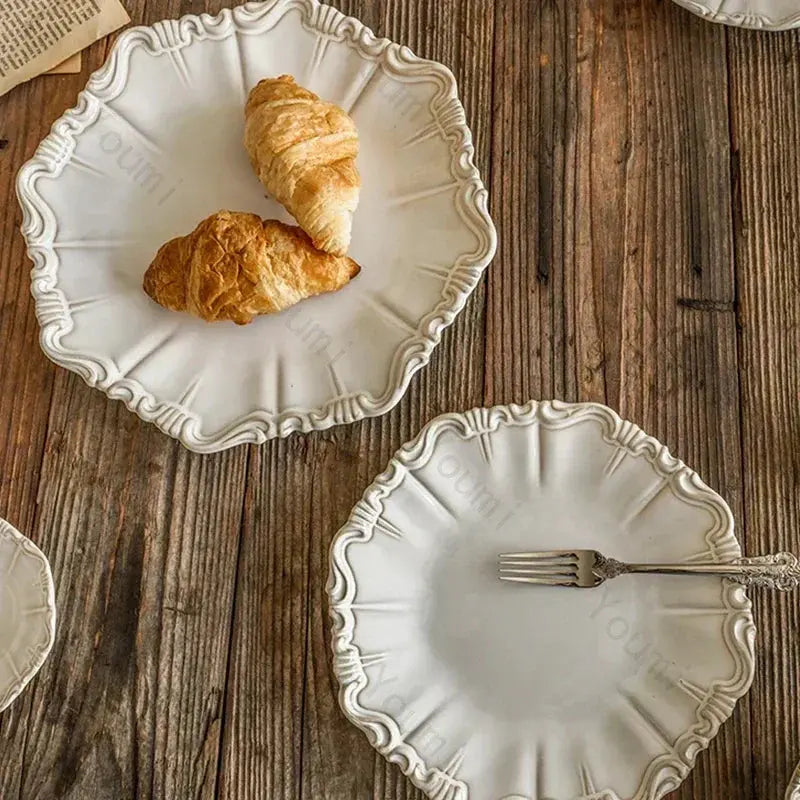 Decorative white plates with croissants and a fork