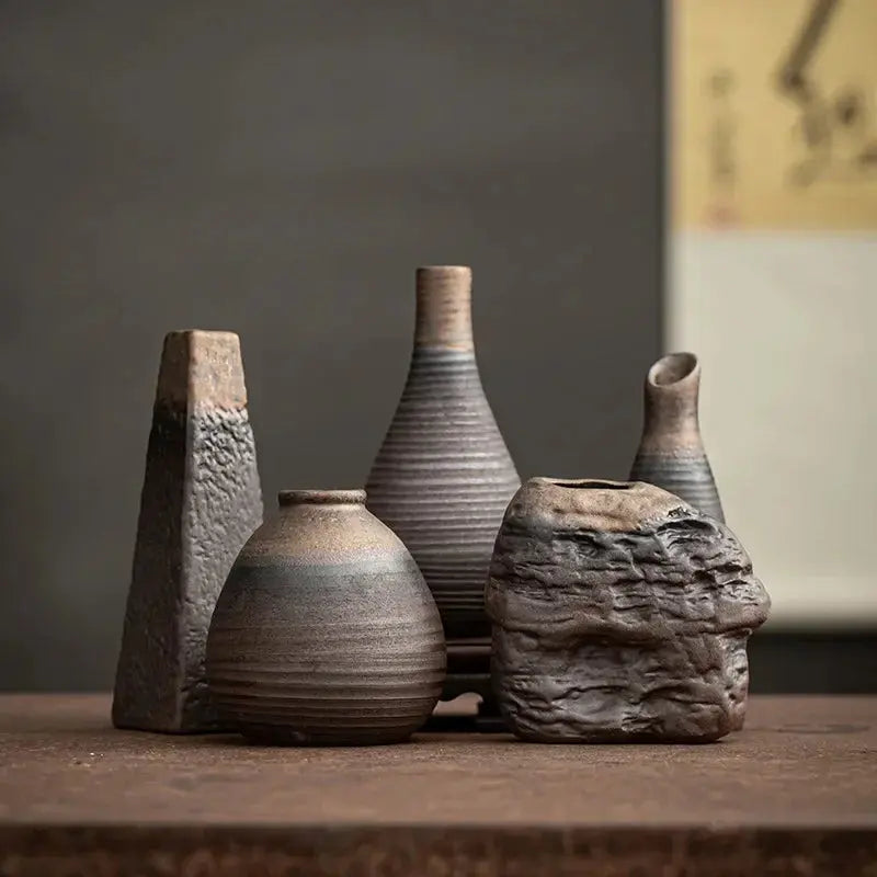 Set of rustic ceramic vases on a wooden sur