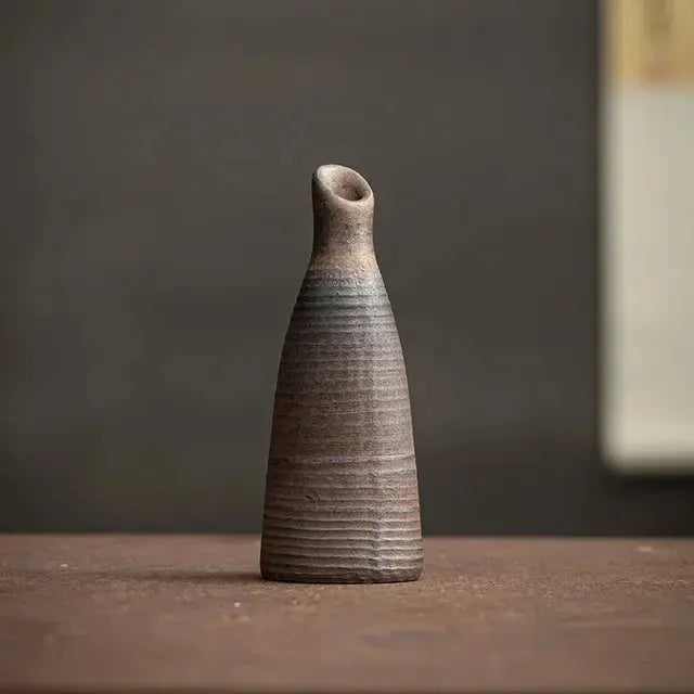 Textured ceramic vase on a wooden surface