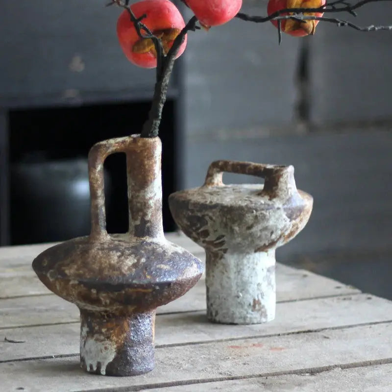 Two rustic ceramic vases with a branch and apples