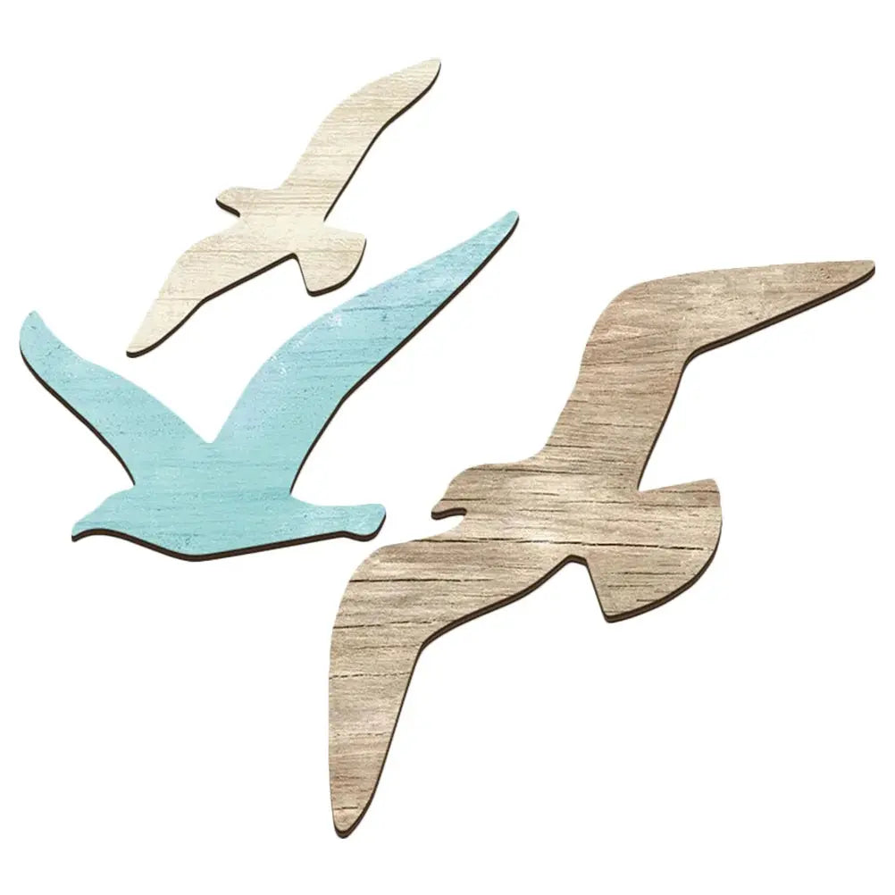 Three wooden bird shapes in different colors on a white