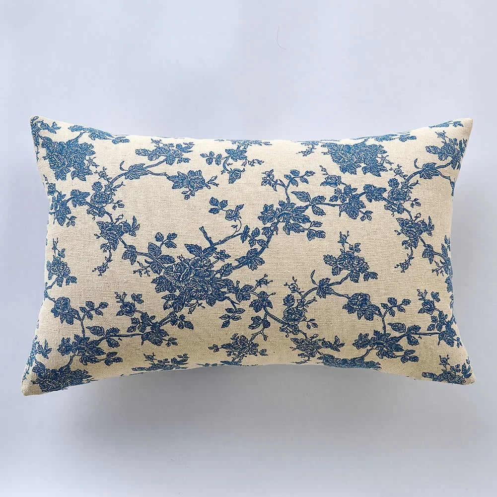 Decorative pillow with blue floral pattern on a beige background