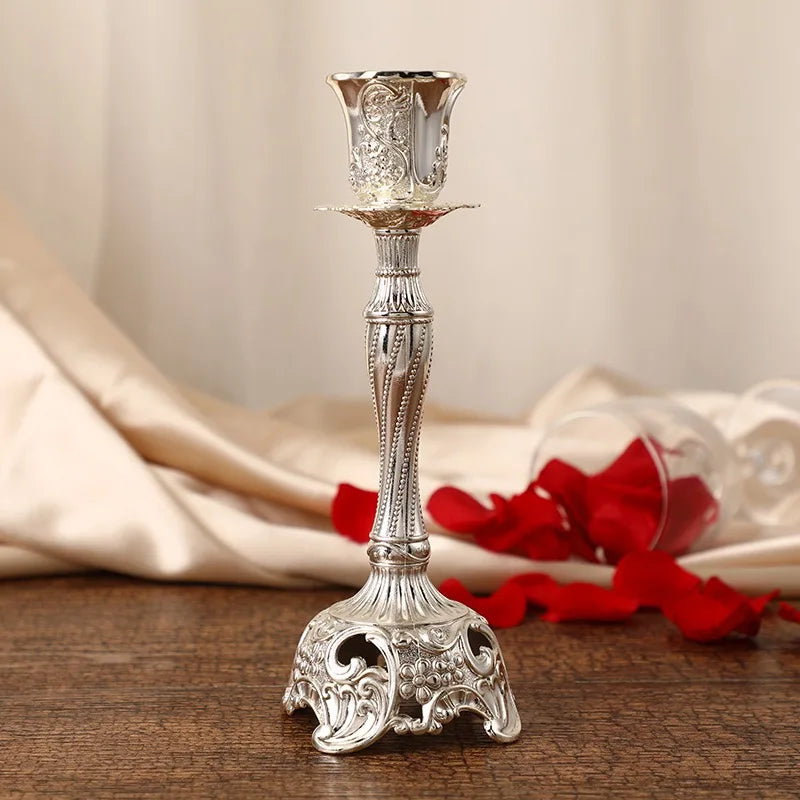 Decorative silver candlestick on a wooden surface with a soft background