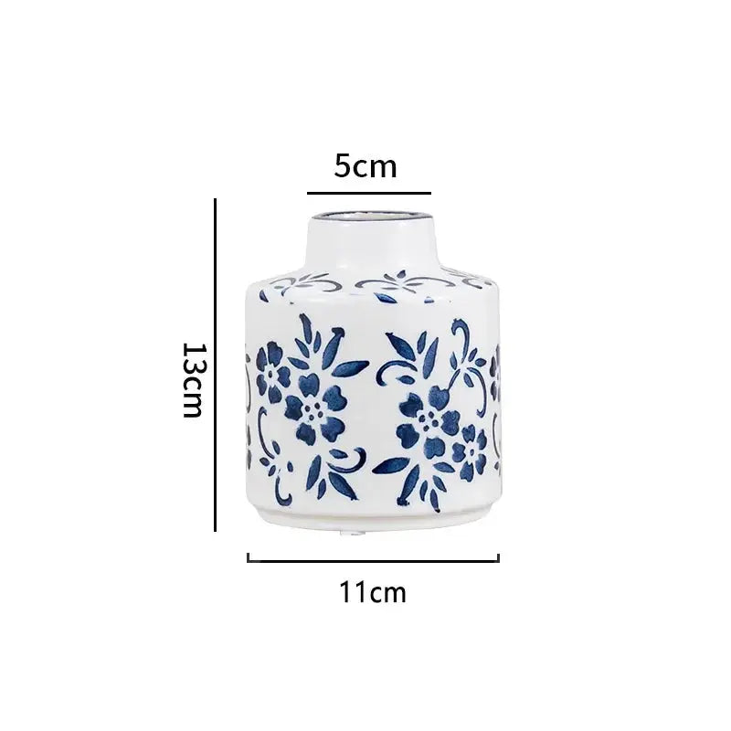 White vase with blue floral patterns and measurements