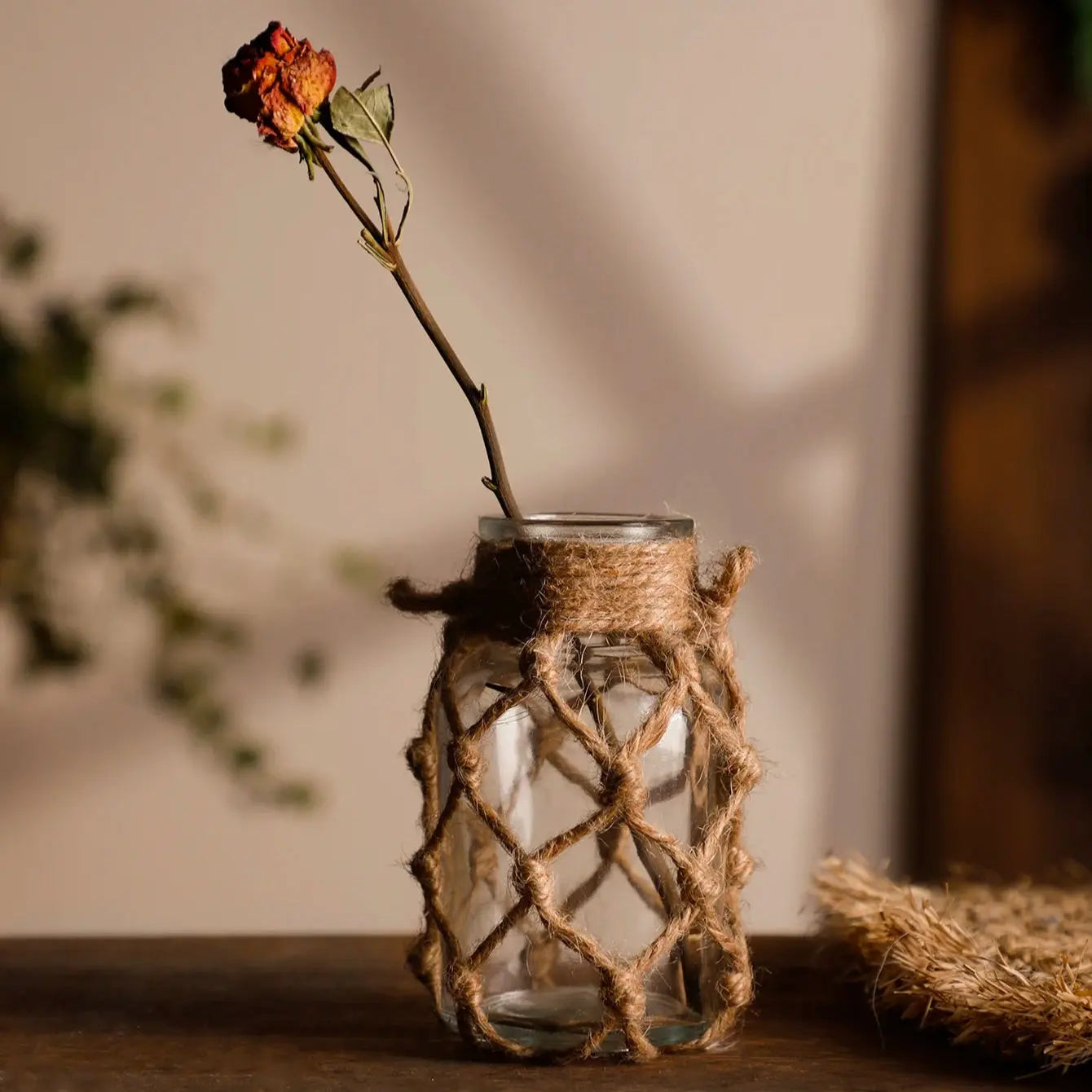 Glass bottle with a dried rose tied with twine