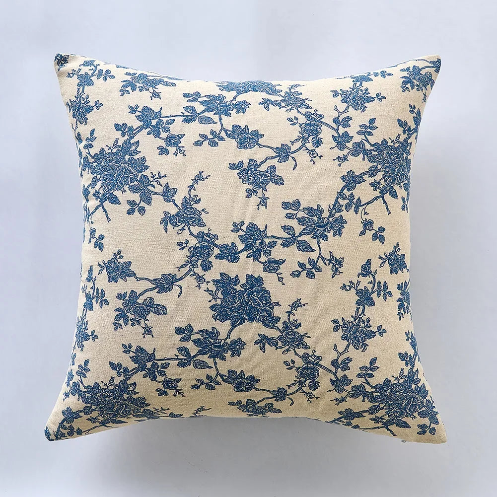 Decorative pillow with blue floral pattern on beige background