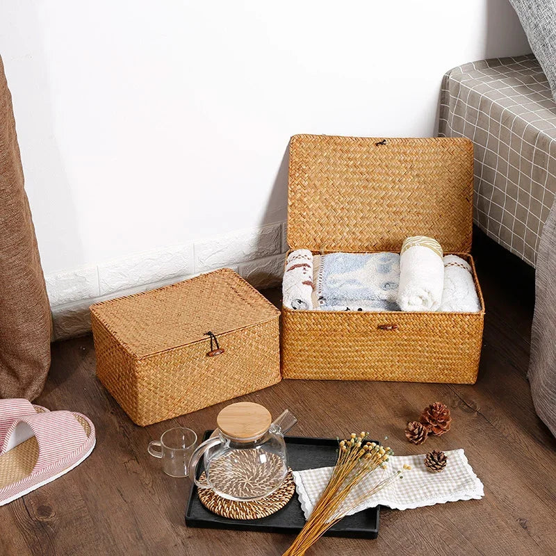 Woven storage baskets on a wooden floor with a glass teapot and tray.