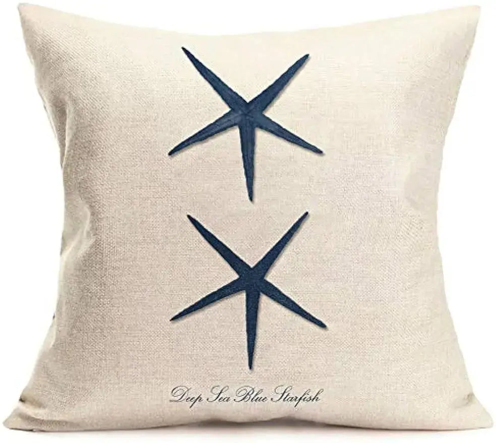 Beige pillow with navy blue starfish design on a white