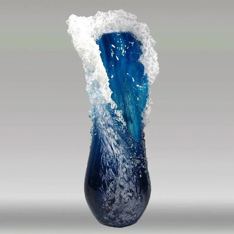 Blue glass vase with white textured top on a gray background