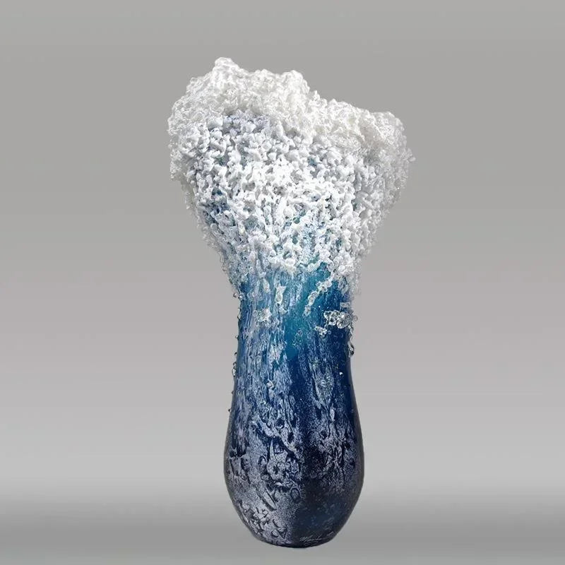 Vase designed to look like a wave with blue and white colors on a gray background
