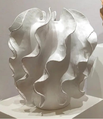 Abstract white sculpture on a gray background