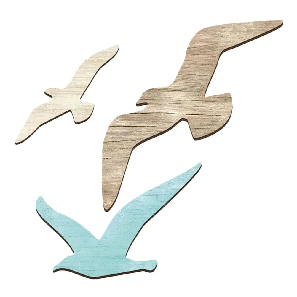 Three wooden bird shapes in different colors on a white